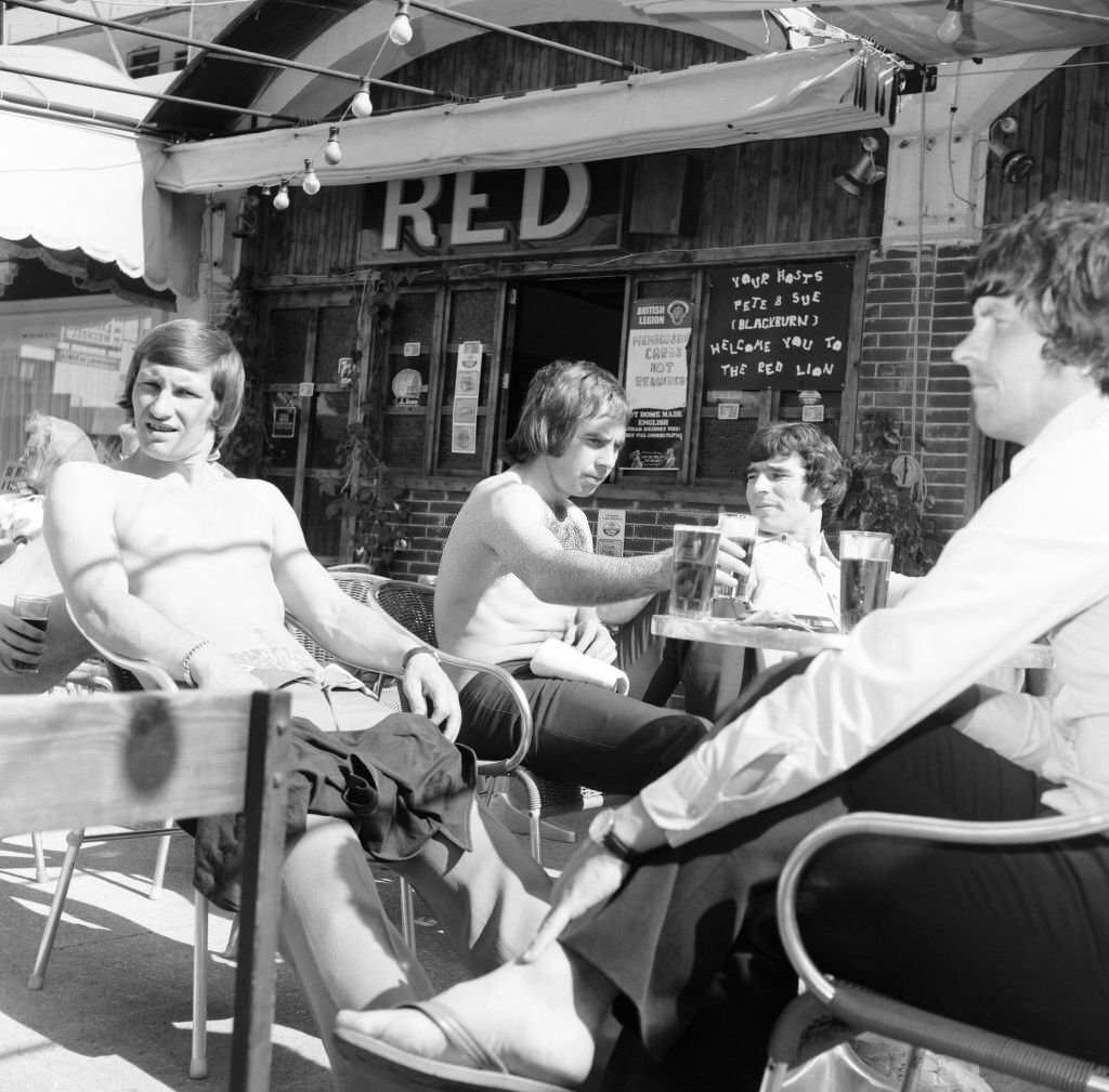#11 Derby County players in Majorca as they celebrate their League Titile win. Having a few pints in the Red Lion in Magaluf, 29th April 1975.