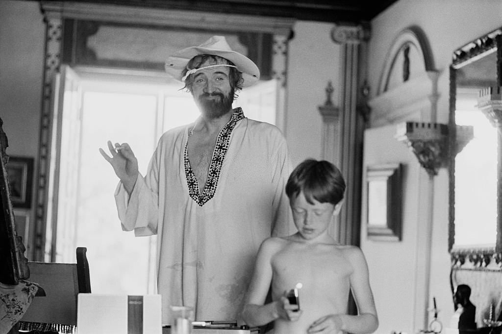 #52 Irish actor Richard Harris with a young boy whilst on holiday in Majorca, 1971.