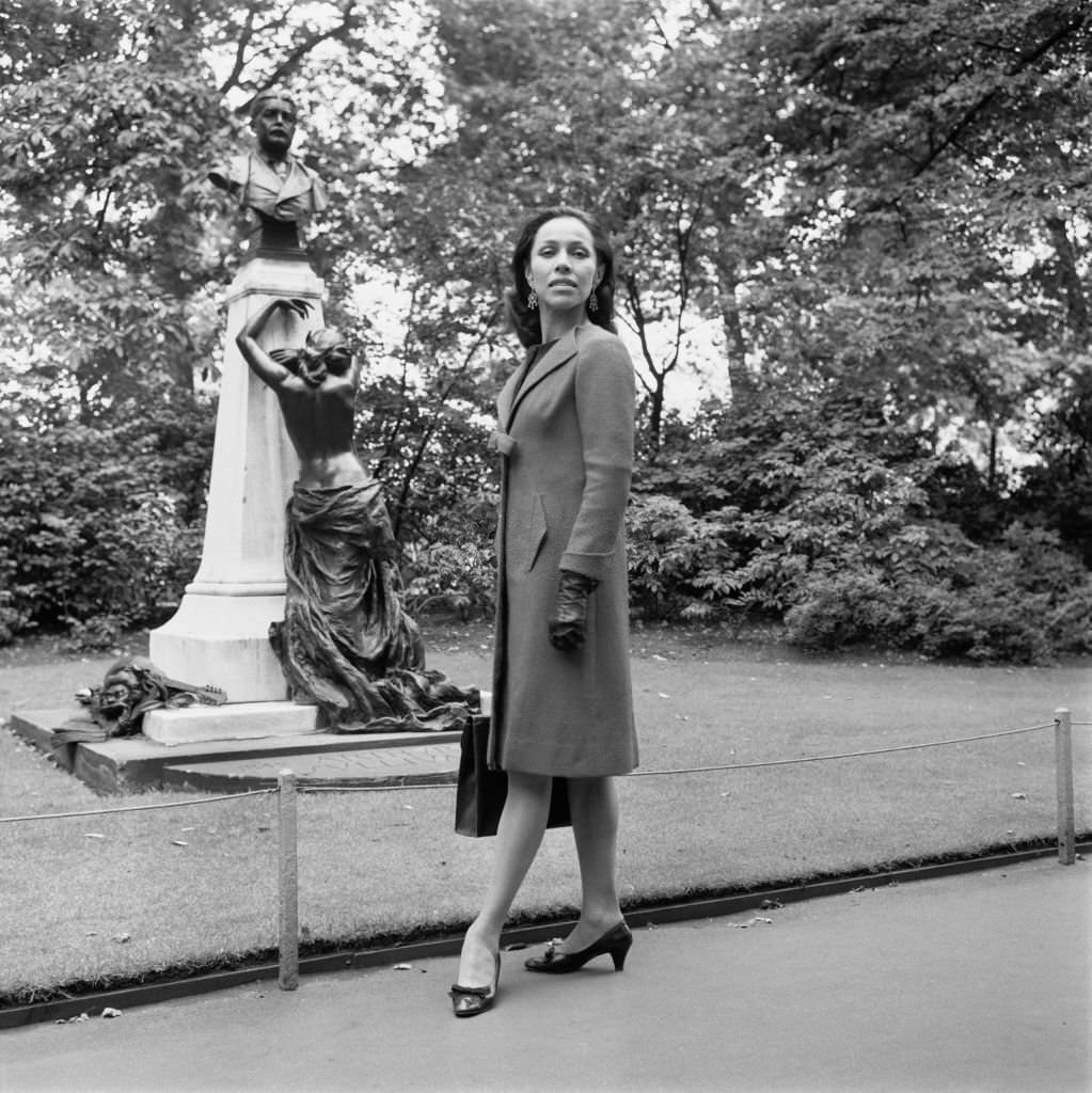 #112 Maria Tallchief in Victoria Embankment Gardens, London, next to the memorial of composer Arthur Sullivan, 28th August 1965.