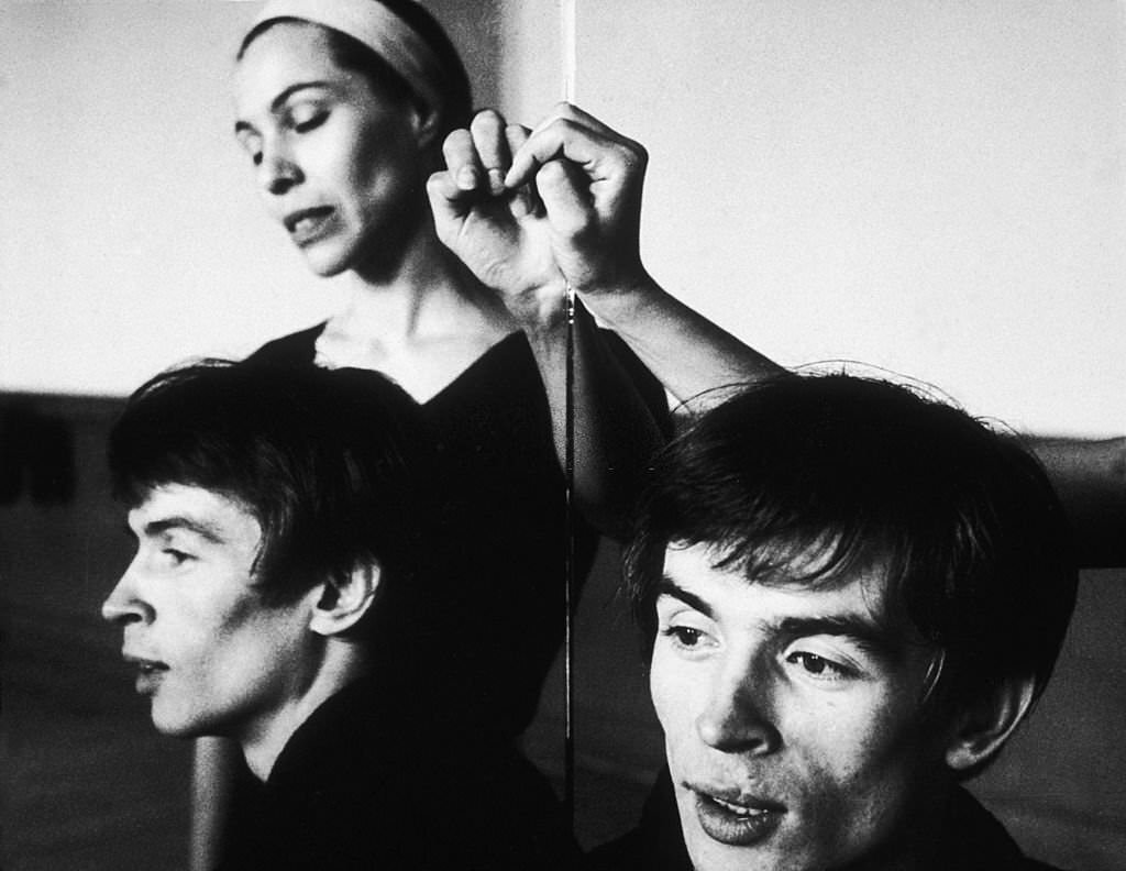 #113 Maria Tallchief and Rudolf Nureyev are reflected in a mirror in a dance studio.
