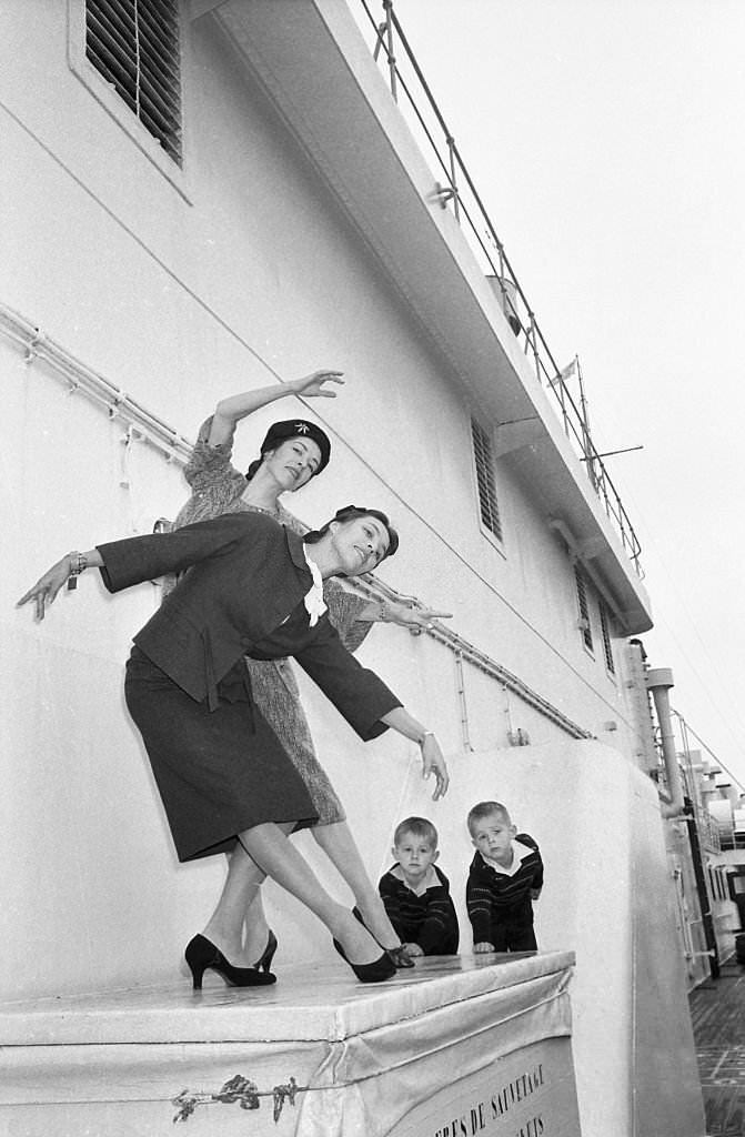 #11 Ballet dancers Marjorie (hat), and Maria Tallchief perform a sister act upon their arrival in New York aboard the liner Liberte.