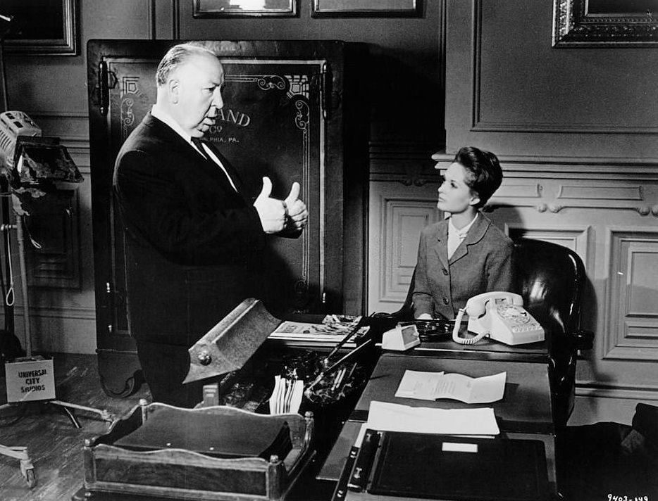 Alfred Hitchcock gives Tippi Hedren directions in between scenes from the film ‘Marnie’, 1964.