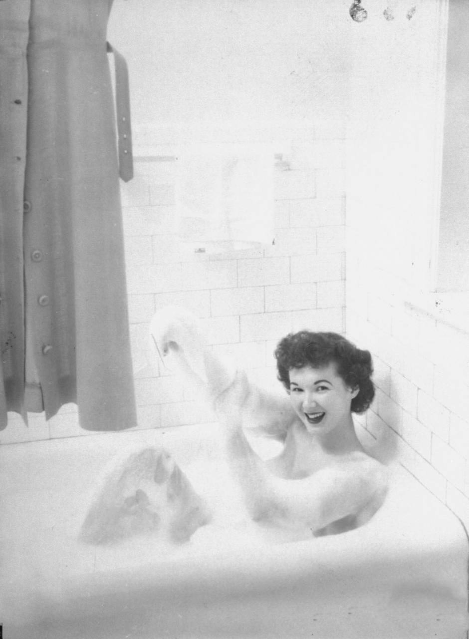 #10 Student at the McConnell Air Hostess School taking a bath.