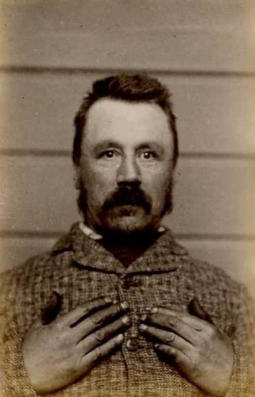 #22 David Kirk Rhodes (b. 1847, England). Charged with 9 counts of embezzlement and sentenced to 3 years on April 4, 1887 (Dunedin). Photograph taken on July 11, 1889.