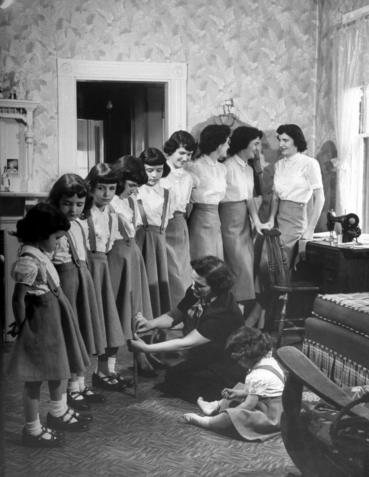 #1 Mrs. O’Neil pinned up hems on all ten of her daughters’ dresses in preparation for Easter, 1952.