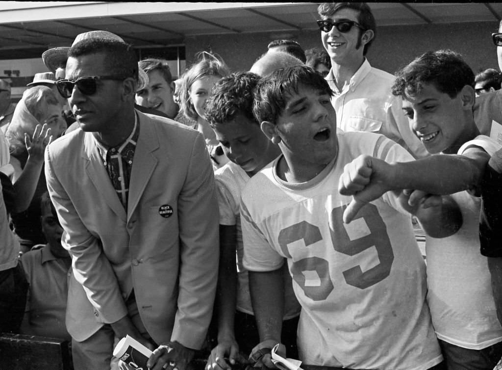 #39 Counter-demonstrators behind a police fence on the Atlantic City Boardwalk, during a Miss America beauty pageant protest, Atlantic City, 1968.