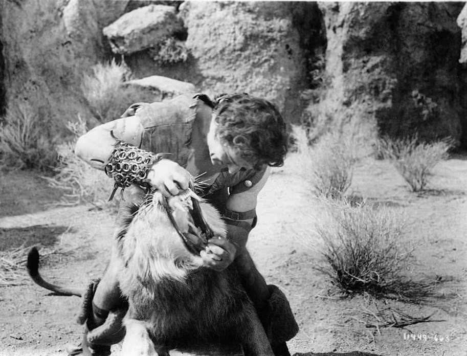Victor Mature opening up mouth of lion in a scene from the film ‘Samson And Delilah’, 1949.