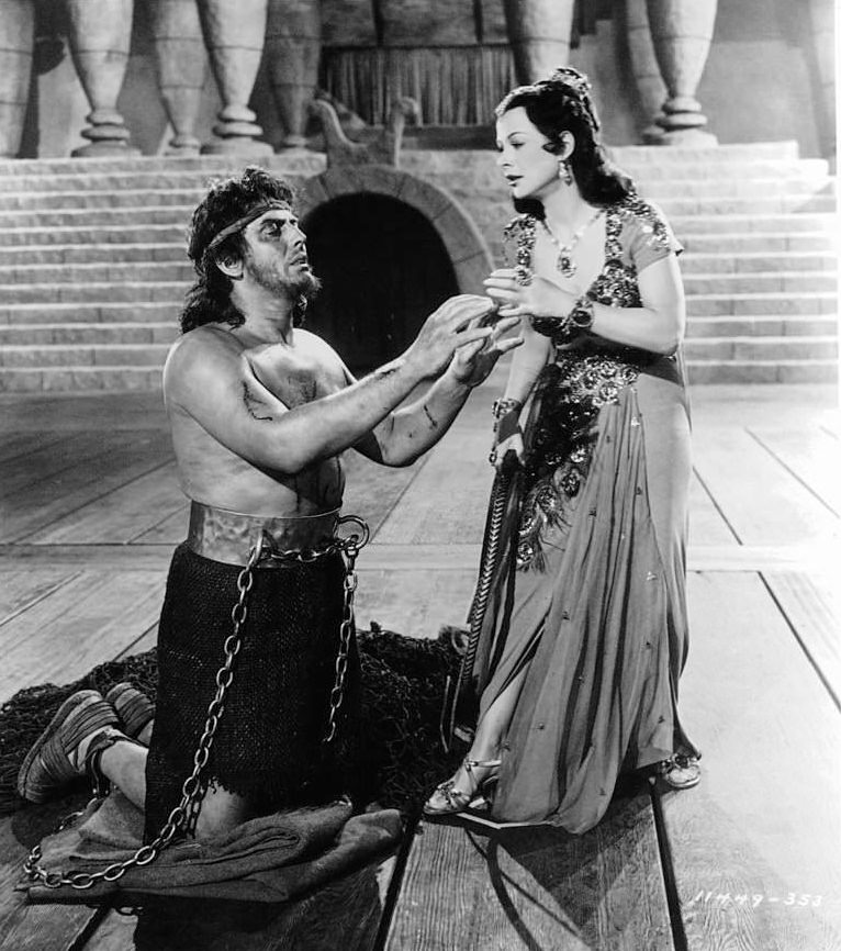 #22 A shackled Victor Mature reaches up towards Hedy Lamarr in a scene from the film ‘Samson And Delilah’, 1949.