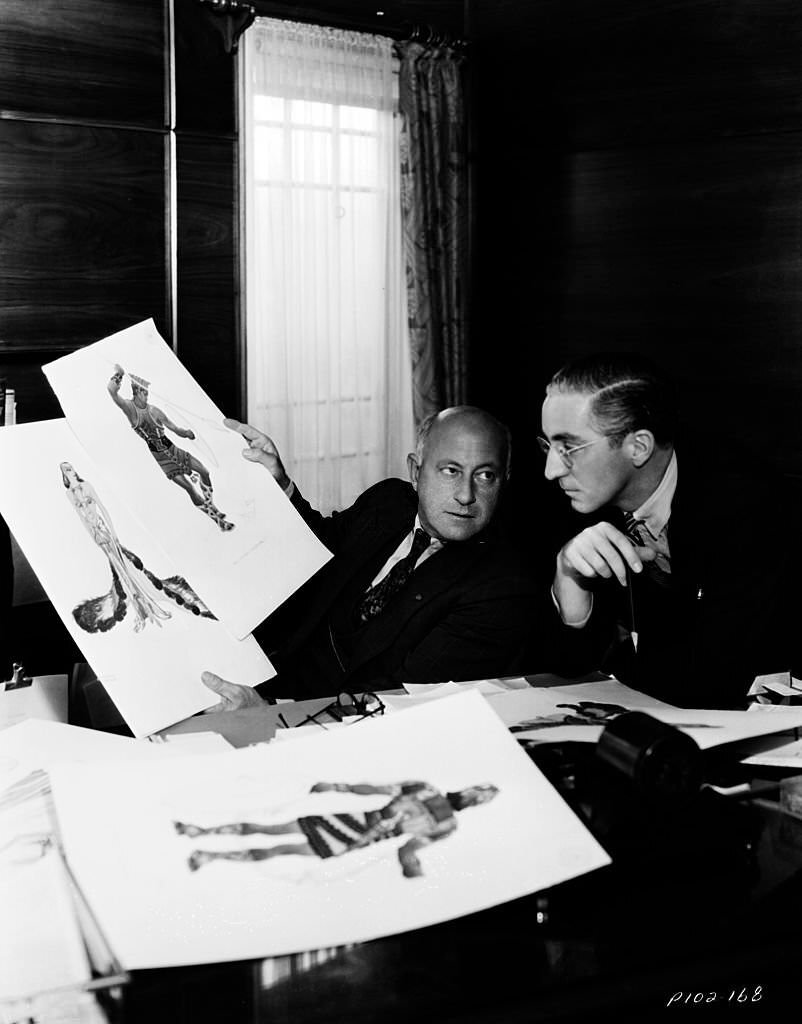 Filmmaker Cecil B DeMille inspecting costume design ideas for the film ‘Samson and Delilah’