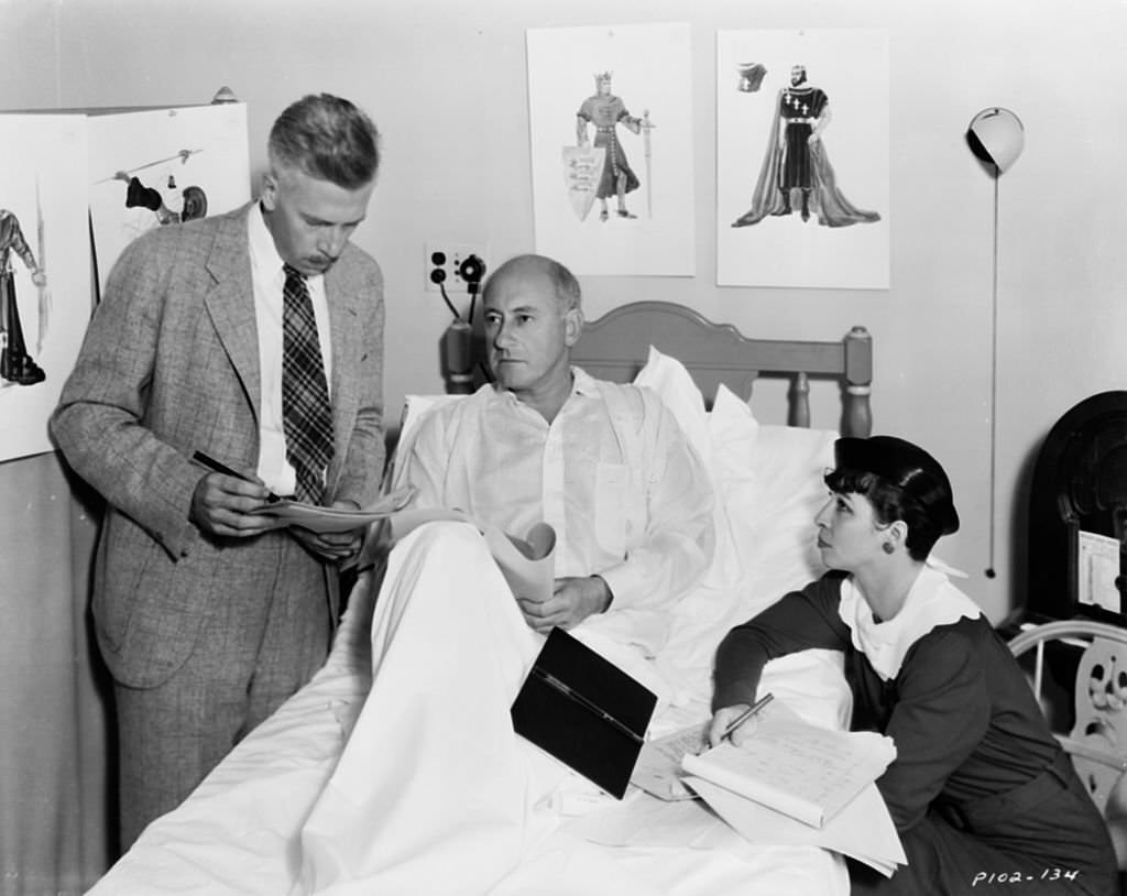 Filmmaker Cecil B DeMille recuperating in bed as his staff discuss the making of the film ‘Samson and Delilah’ 1949