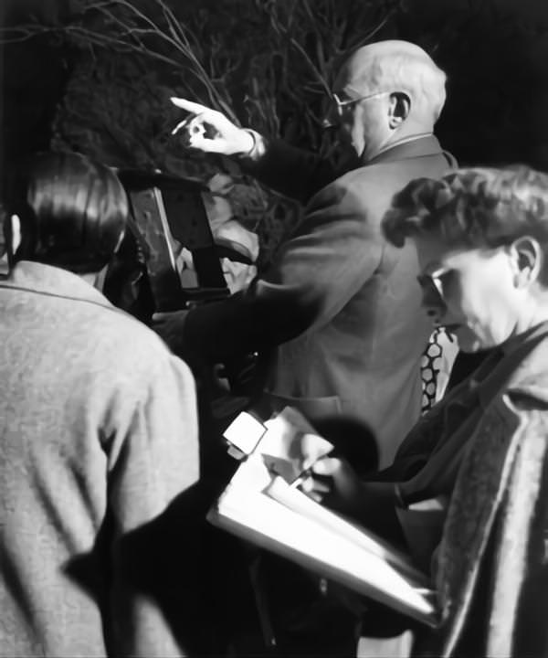 Cecil B DeMille on set candid with Cinematographer George Barnes and Script Supervisor Claire Behnke on-set of the Film ‘Samson And Delilah’, 1949