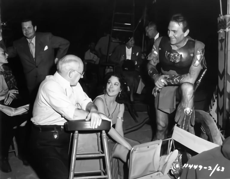 Script Supervisor Claire Behnke, Cecil B DeMille, Hedy Lamarr and Henry Wilcoxon on set candid during filming of ‘Samson And Delilah’, 1949