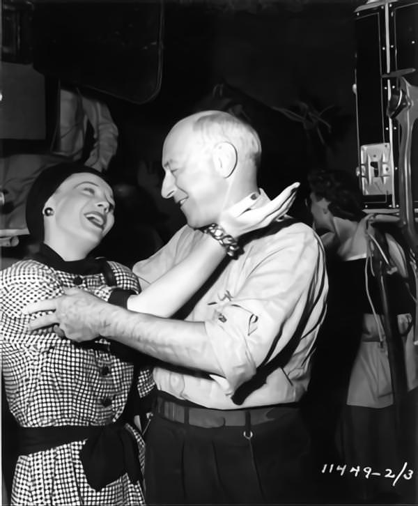 Woman greets Cecil B DeMille on set candid during filming of ‘Samson and Delilah’, 1949