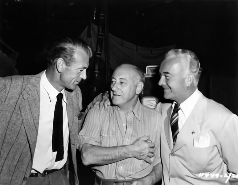 Cecil B DeMille (centre) on set candid with Set Visitors Gary Cooper and William Body during filming of ‘Samson and Delilah’, 1949