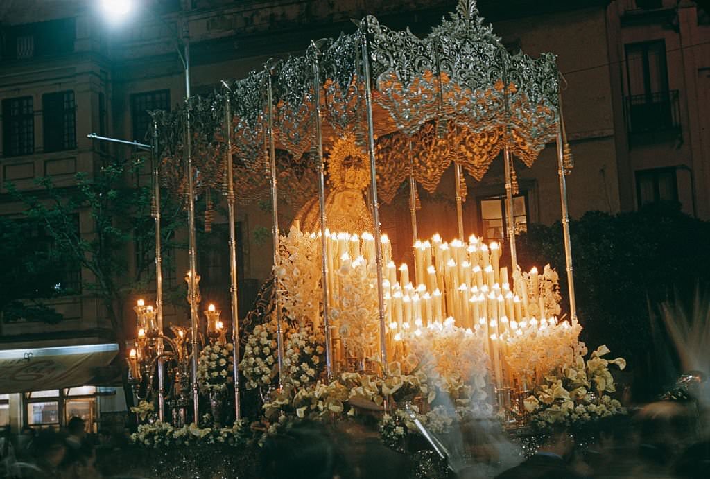 #10 A paso or float surmounted with an effigy of the Virgin Mary during Semana Santa or Holy Week in Spain, probably Seville, 1960.