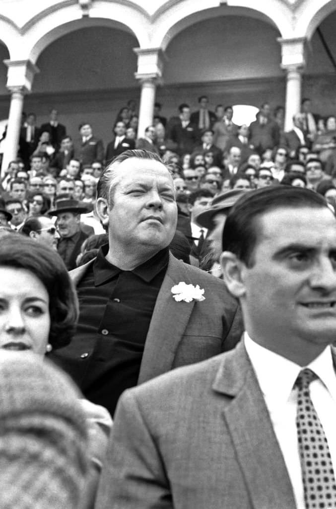 #24 American film director and actor Orson Welles enjoys a bullfight in Seville during the Feria de Abril.