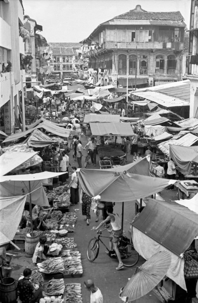 #103 People crowding an outdoor market in Singapore, 1962