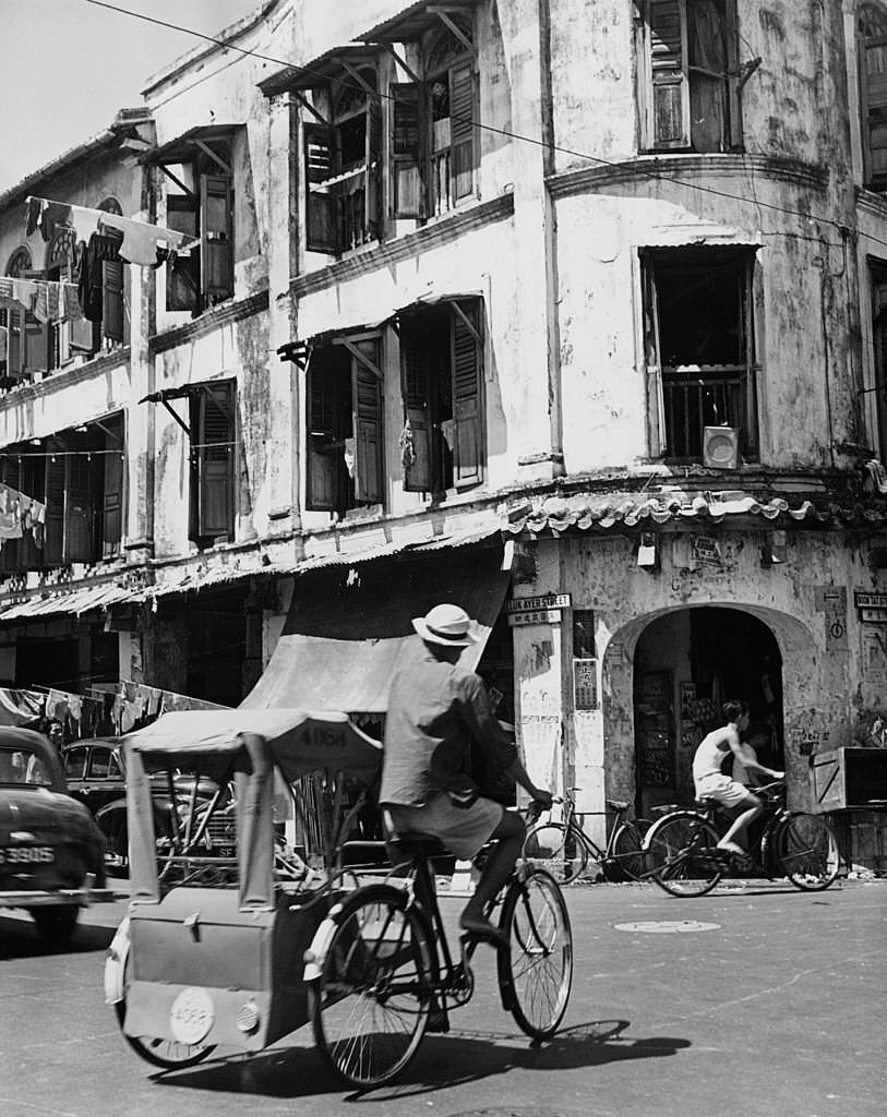 #105 A rickshaw at the corner of Telok Ayer Street and Boon Tat Street, Singapore, November 1960.