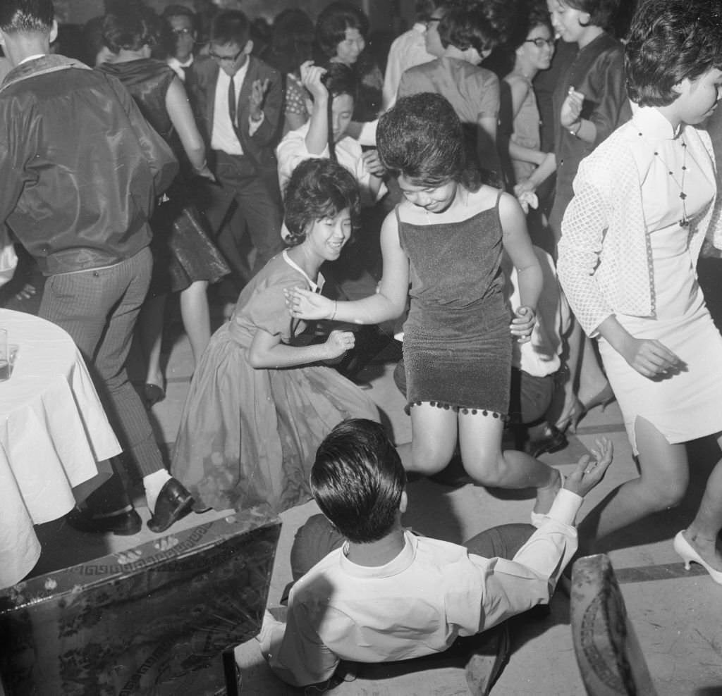 #28 People dancing the twist in the Celestial Room of the Amber Mansion, a nightclub in Singapore, 1963