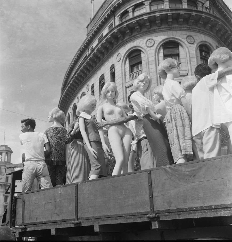 #43 A truck load of dummies as the driver makes his way through the traffic in the heat of the morning sun on its way to the fine Asia Insurance building, 1962