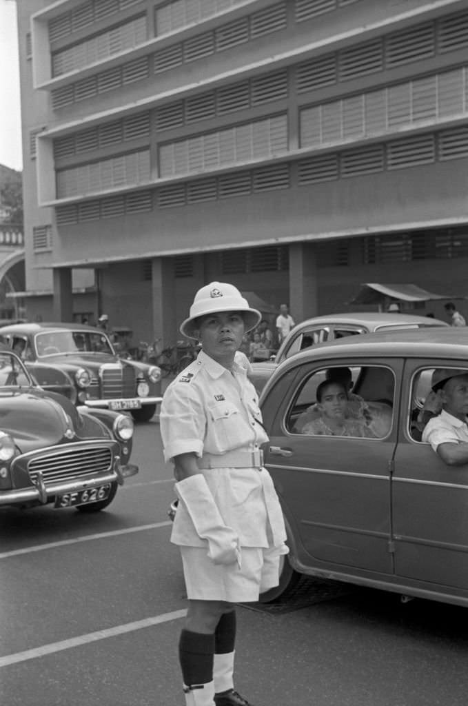 #72 Traffic policeman directing traffic in a street of Singapore, 1962