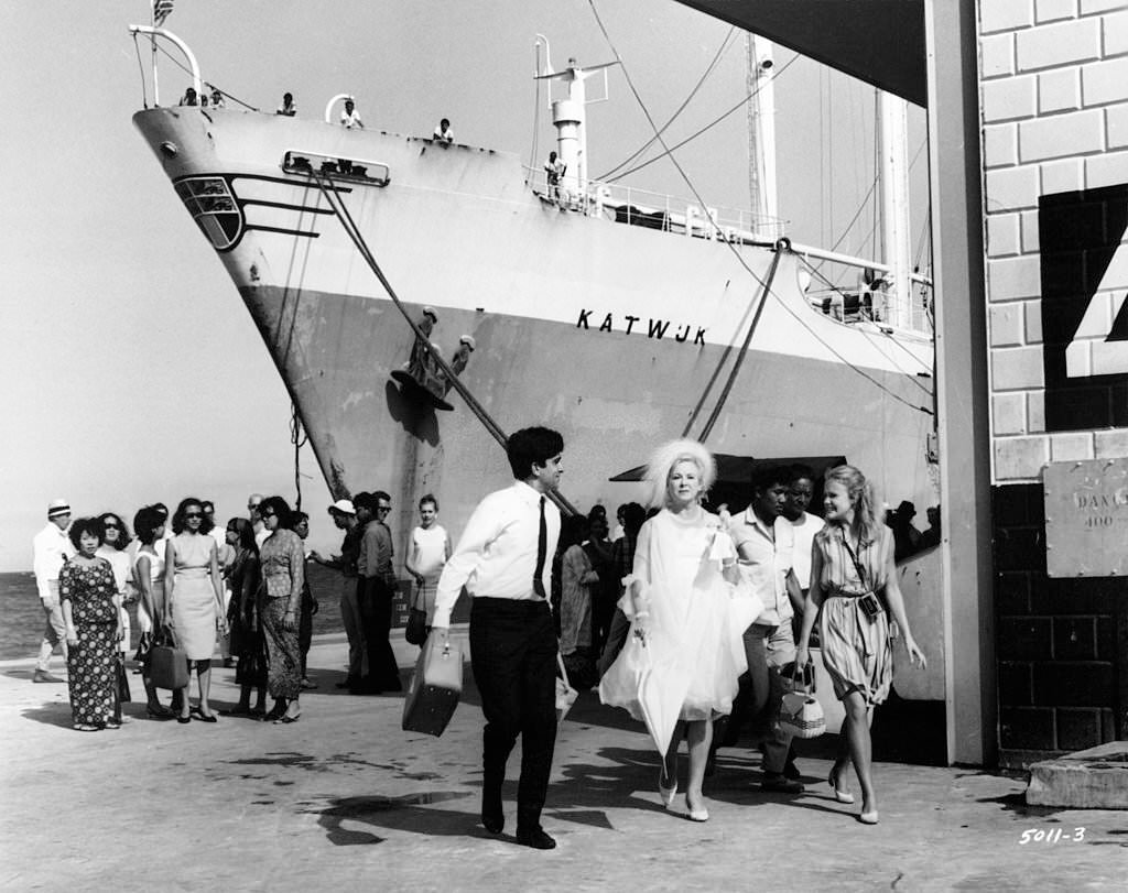 #9 As Brenda de Banzie and Hayley Mills disembark from a cruise ship at Singapore, they are met by Shashi Kapoor in a scene from the film ‘A Matter Of Innocence’, 1967.