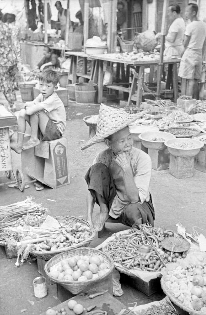 #87 Street vendor displaying his goods in an outdoor food market, Singapore, 1962