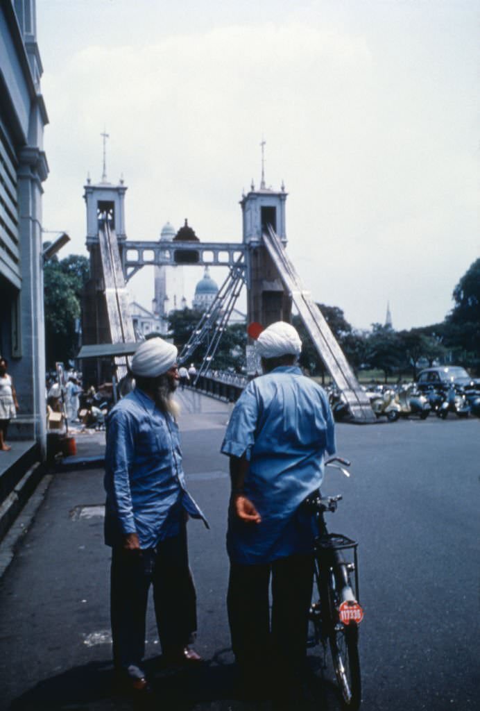 #95 Two men with turban chatting in the street, Singapore, 1962