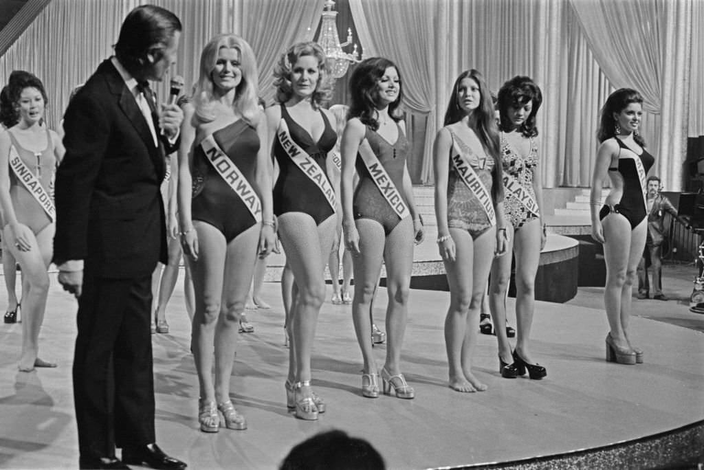 #12 British television host Eric Morley meets some of the contestants in the Miss World 1972 beauty pageant in London.
