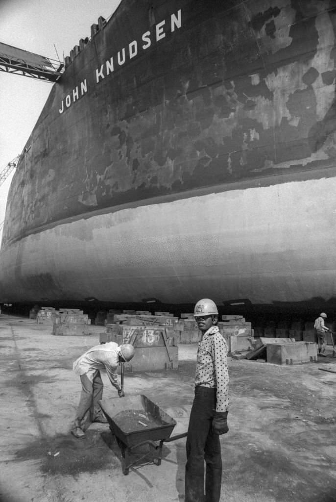 #41 Workers in front of the liner “John Knudsen” in dry dock at a Singapore shipyard, July 1974.