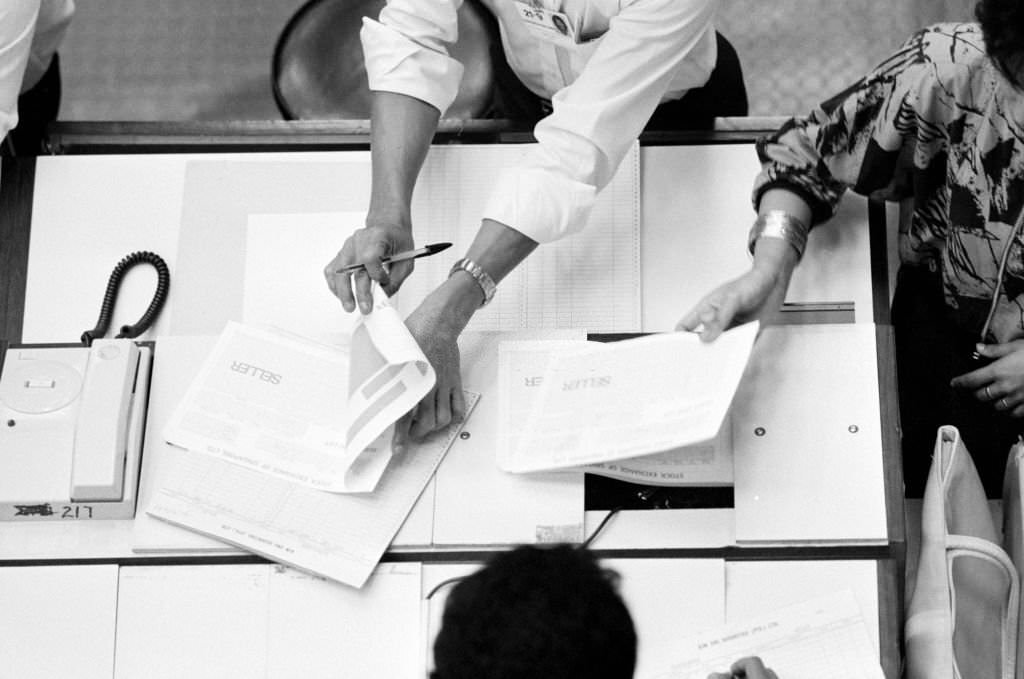 #11 The Singapore Stock Exchange. Bird’s eye view of broker hands, 1987