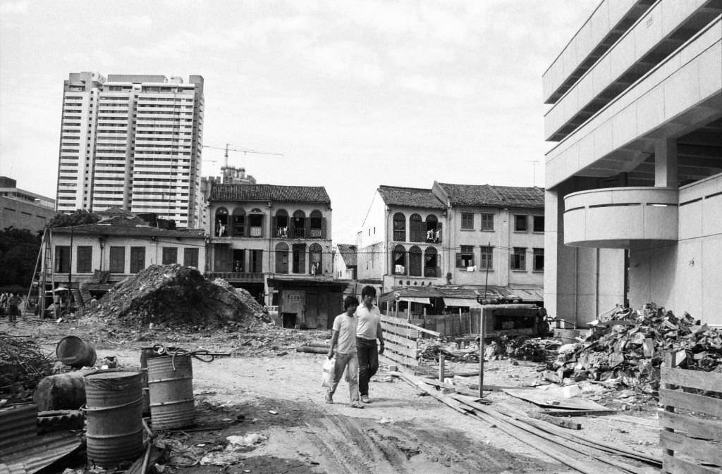 #39 Rubble-strewn vacant lot awaits redevelopment alongside the Chinatown Complex on the corner of Smith St and New Bridge Rd, 1983