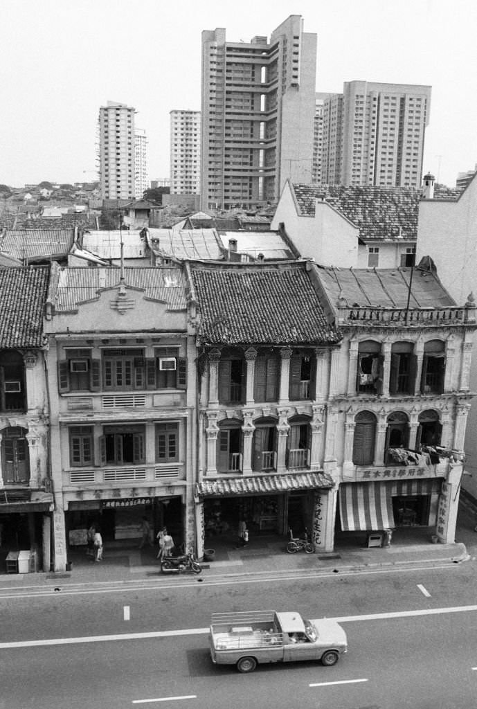 #53 Shophouses on Upper Cross St seen before their residents are relocated in September 1983, and before being restored following conservation status in 1989, Chinatown, Singapore,