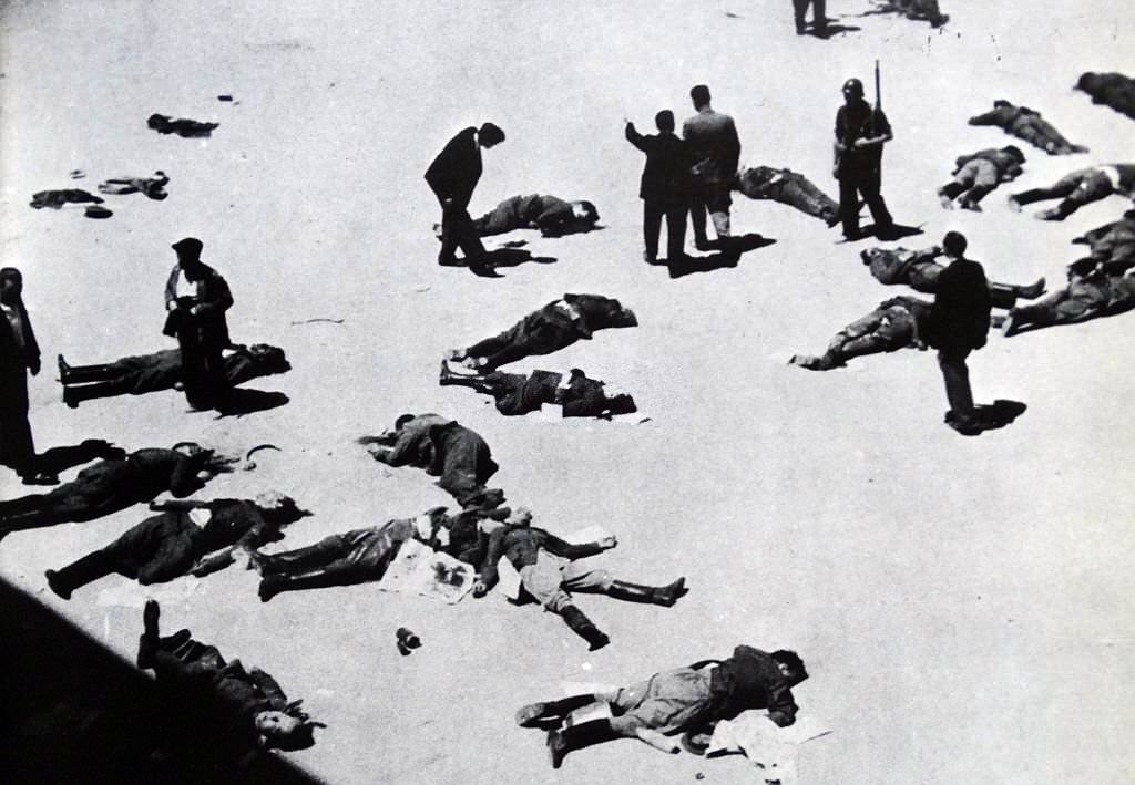 #118 Anti-fascist militias survey their casualties after the capture of the Montaña barracks in Madrid from nationalist forces led by General Joaquín Fanjul, commander of the military garrison. Spanish Civil War July 1936.