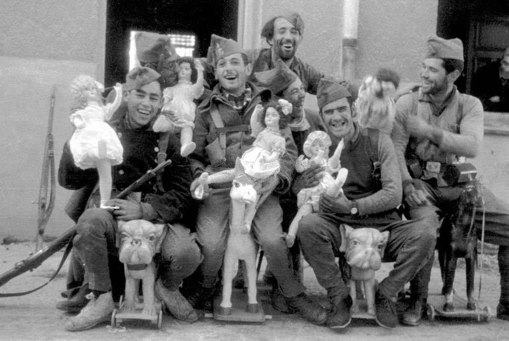 #12 A group of soldiers posing with dolls, 1936