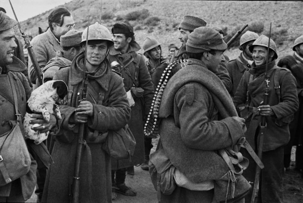#123 Writer and journalist Ernest Hemingway talks with Republican soldiers before they go into action on the Aragon front during the Spanish Civil War at the Battle of Teruel on 21st December 1937 near Teruel, Aragon, Spain.