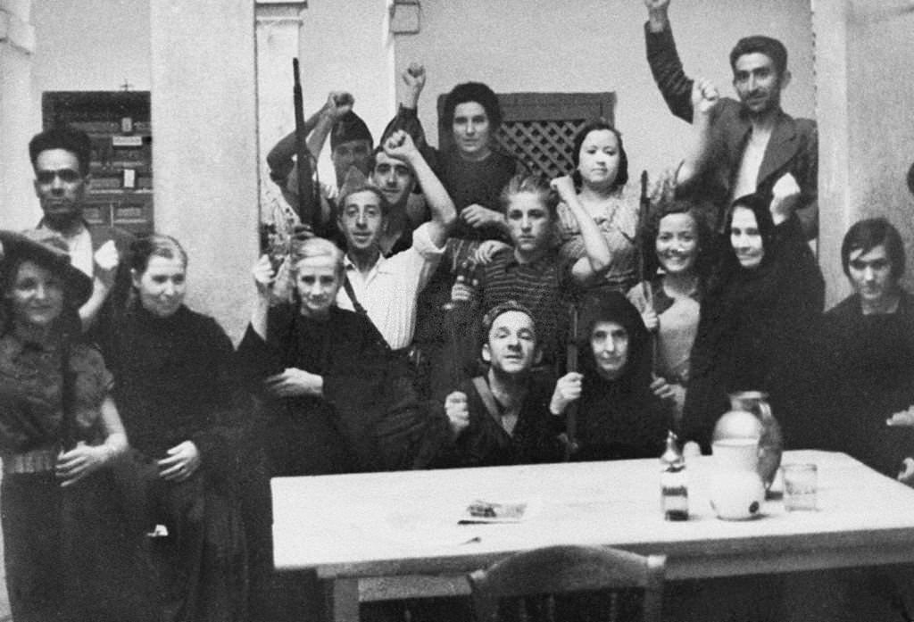 #137 A group of nuns in civilian clothes, protected by governmental militimen in a Toledo’s convent, during the Spanish civil war.