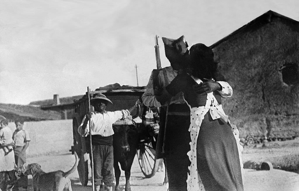 #146 On the Talavera de la Reina front, a militiaman is kissing his wife during the retaking of a village by the Government.