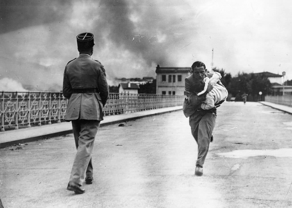 #155 Refugee woman runs towards the Spanish French border, during the Spanish Civil War.