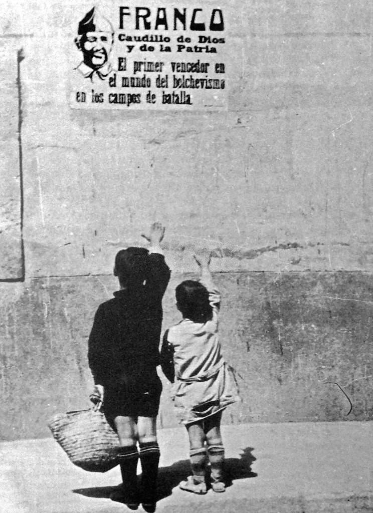 #161 Children salute General Franco on a wall poster in Spain, during the Spanish Civil War, 1937.