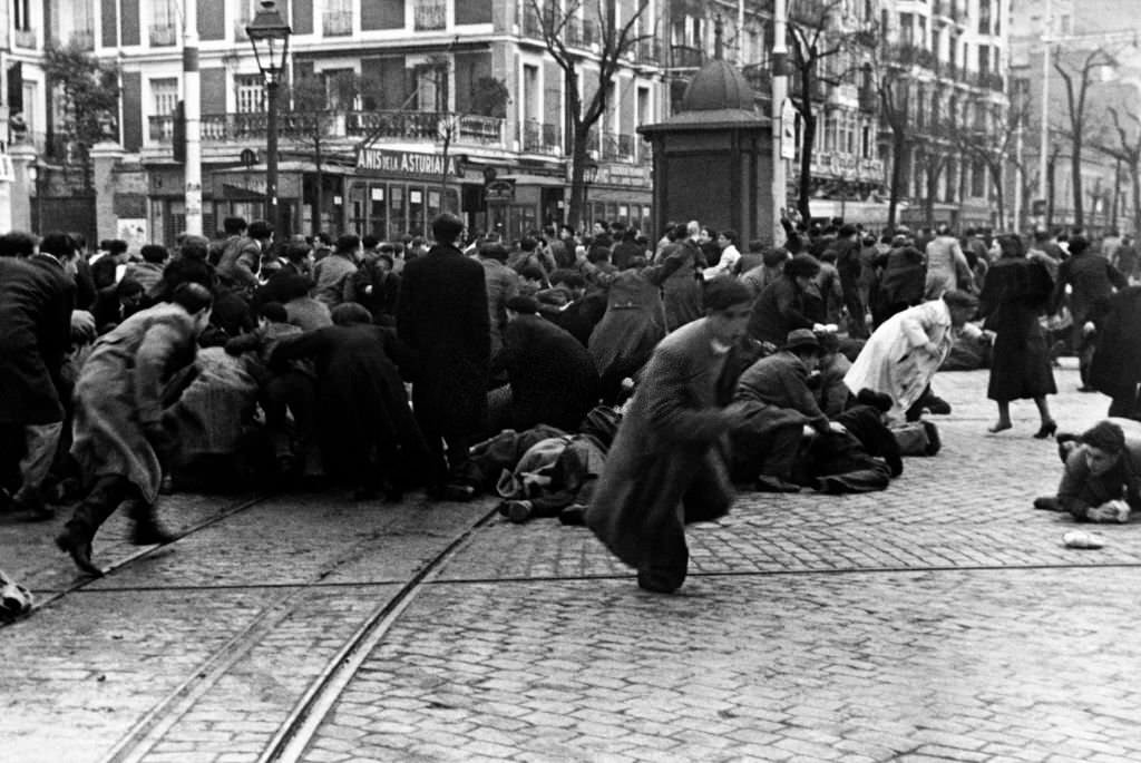 #2 Demonstrators run during a violent demonstration in the streets of Madrid ahead of the February 16, 1936 parlimentary elections that saw the rise to power of the Frente Popular.