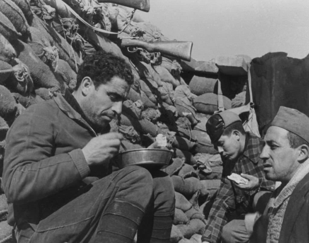#28 Government troops have a meal in their front line trench during the Spanish Civil War.