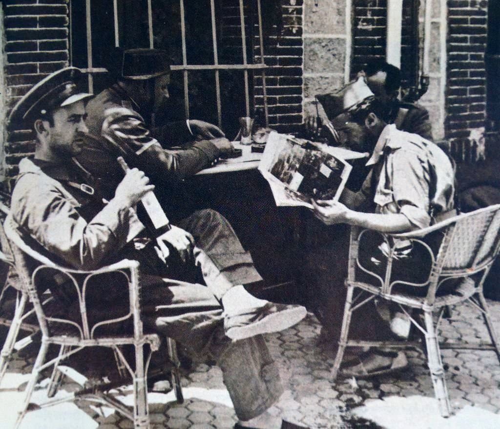 #69 Nationalist troops rest at a café in Guadarrama during the Spanish civil war 1936.