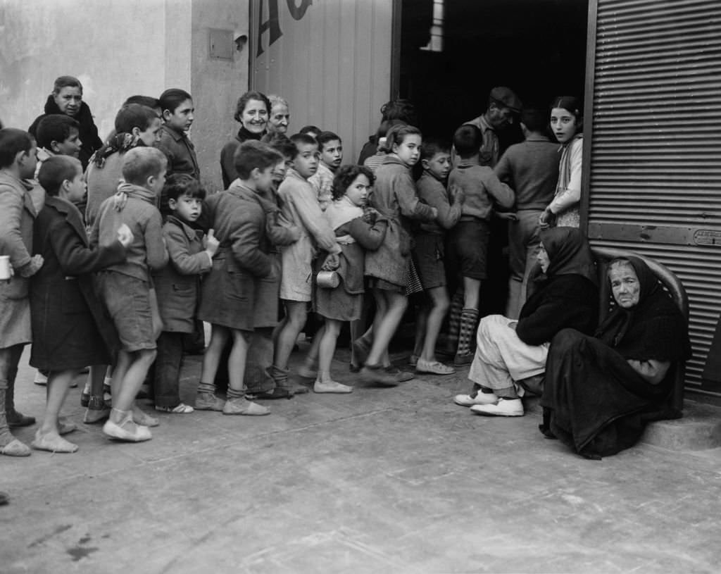 #86 Children queuing for milk rations, Spanish Civil War, December 1937