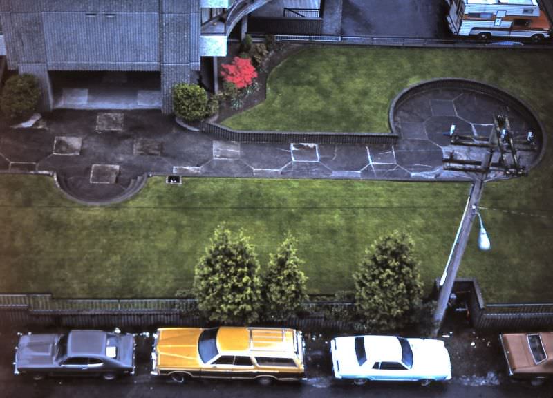 #88 View of back laneway parking and apartment building lawn as seen from Burnaby Street apartment, Vancouver, 1982