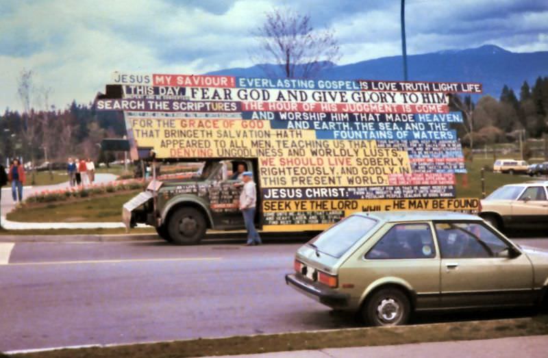 #12 Truck with Christian religious signs parked near the entrance to Stanley Park at Denman and Georgia Streets, Vancouver, 1987