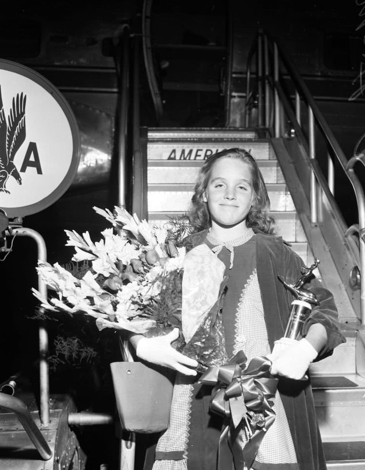 #10 Martha Ann Williams from Long Beach returns home via American Airlines after 30 days tour competing in water skiing, 1957
