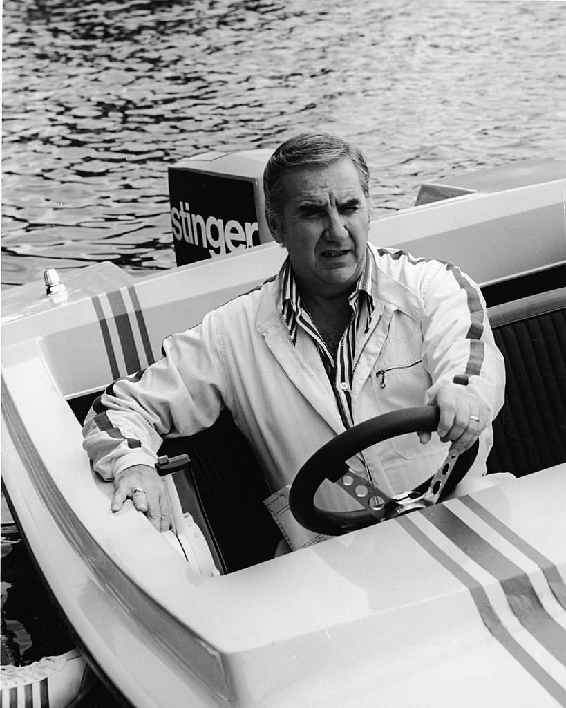 #120 American television host Ed McMahon sits behind the steering wheel of a motorboat at Cypress Gardens, Florida, 1972.