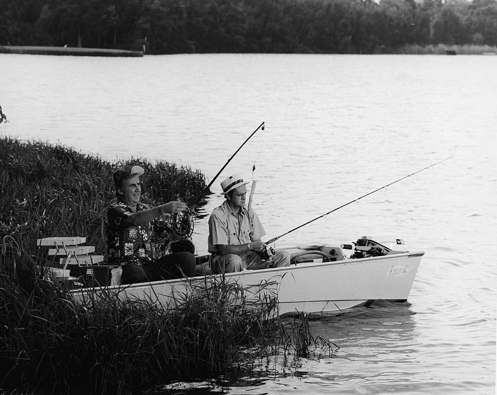 #122 American television host Ed McMahon fishes with actor and comedian Bob Newhart from a rowboat in Cypress Gardens, Florida, 1972.