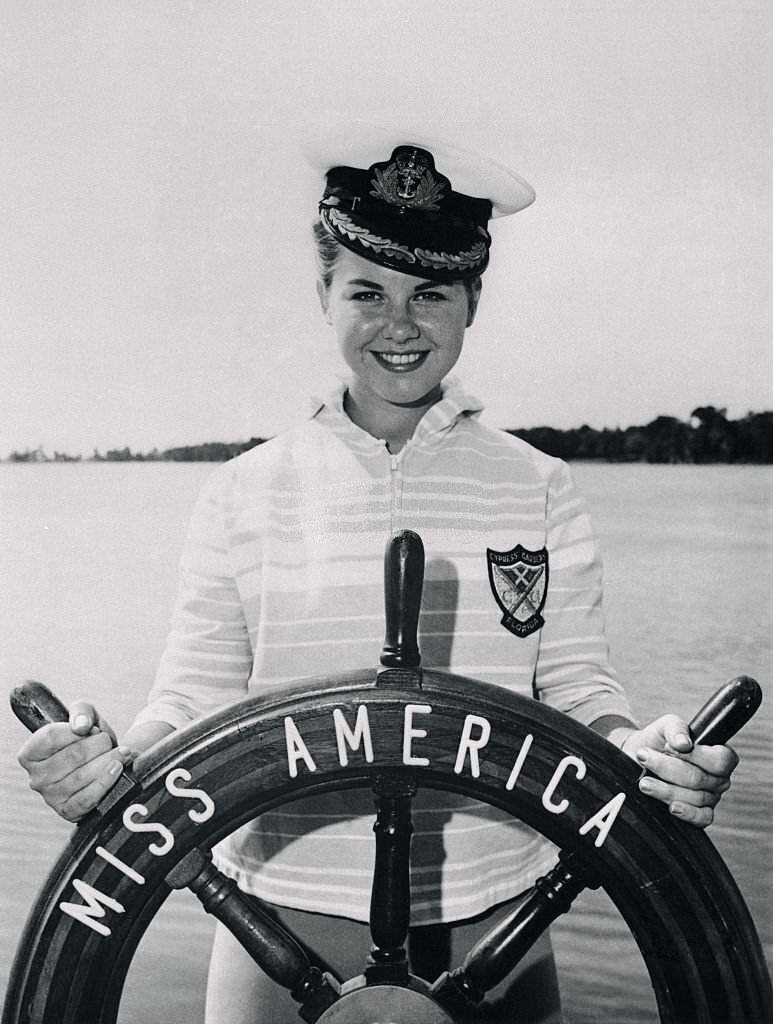 #132 Miss America Debra Barnes Posing at Helm